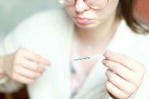 Negative pregnancy test. The woman was upset. holding the test in hand. not pregnant photo