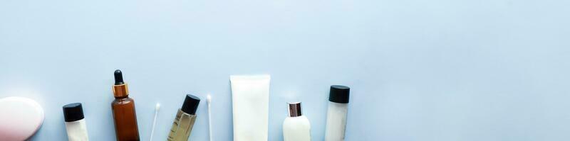 Banner Flat lay cosmetics on a blue background. Spa. beauty procedures. photo