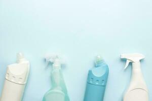 Flat lay cleaning on a blue background. Cleaning tool mockup. Spray for cleanliness. Toilet cleaning bottle photo