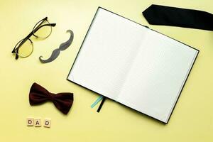 Mockup diary on a yellow background. Flat lay happy fathers day photo