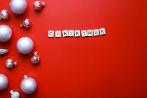 Flat lay Christmas toys on a red background. Word christmas from letters on red background photo