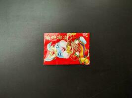 Look at the red angpao envelope as a gift for Chinese New Year photo