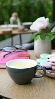 Still life composition with cup of tea and desserts on outdoor cafe table. High quality FullHD footage video