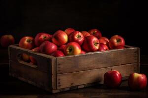 Red apples in wooden box photo