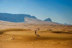 Yellow desert and mountaines.Unaited arab Emirates photo