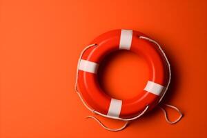 A red lifebuoy on red background with copyspace. photo