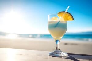 Blue Curacao cocktail on the beach with blue sky and sea background. photo