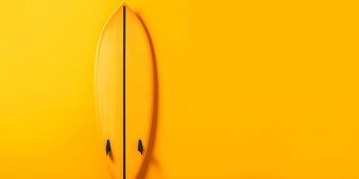 Surfboard on yellow background with copy space. photo