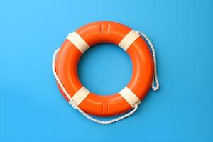 Orange lifebuoy on blue background with copyspace. photo