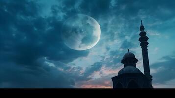 A Mosque and moon in the night sky. photo