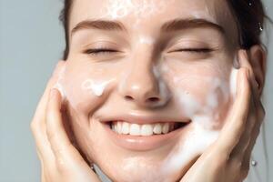 Closeup portrait of young woman cleanses the skin with foam on her face in bathroom. photo