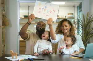 Happy African American parent playing and drawing with daughters in home photo