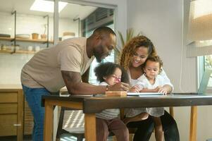 Happy African American parent playing and drawing with daughters in home photo
