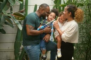 Portrait of Happy African American family enjoying gardening at home photo