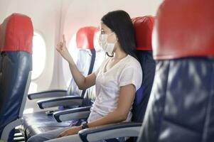 People is touching virtual screen in airplane , modern technology and transportation concept. photo