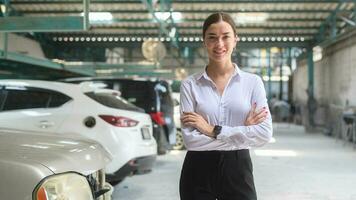 Portrait of young beautiful caucasian woman smiling in auto repair shop . concept of auto repair and maintenance service. photo
