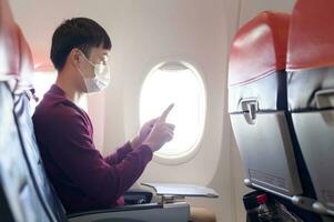 People is touching virtual screen in airplane , modern technology and transportation concept. photo