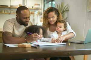 Happy African American parent playing and drawing with daughters in home photo