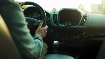 Man drives a car along the road, the setting sun shines in the windshield video