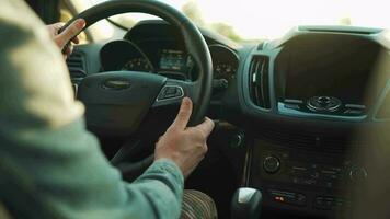 Man drives a car along the road, the setting sun shines in the windshield video