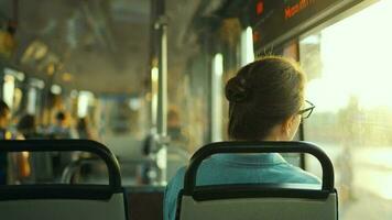 Woman in tram using smartphone chatting and texting with friends, back view video