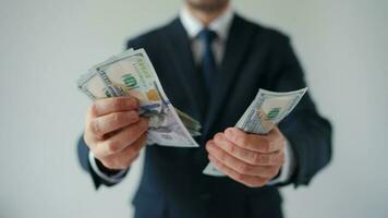 Formally dressed man counting US Dollar bills, close-up video