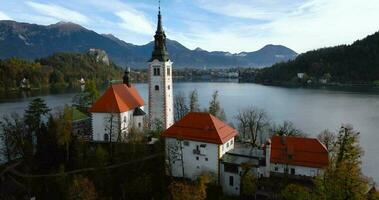 Aerial view of lake Bled and the island in the middle of it, Slovenia. Pilgrimage Church of the Assumption of Mary In Lake Bled video