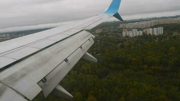 Airplane wing view from window seat. Plane landing, descending, arrival video