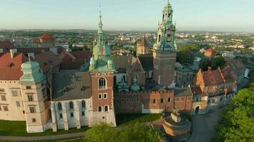 Aerial view of Wawel royal Castle and Cathedral early morning at dawn. Panorama of the city is visible in the background video