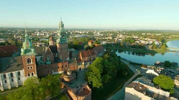 Aerial view of Wawel royal Castle and Cathedral early morning at dawn. Panorama of the city is visible in the background video