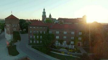 Aerial view of Wawel royal Castle and Cathedral early morning at dawn. Panorama of the city is visible in the background video