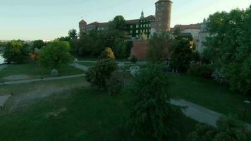 Aerial view of Wawel royal Castle and Cathedral early morning at dawn. Panorama of the city is visible in the background video