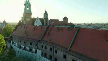 Aerial view of Wawel royal Castle and Cathedral early morning at dawn. Panorama of the city is visible in the background video