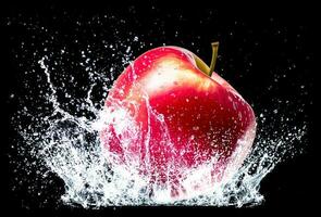 red apple on water splash on black background photo