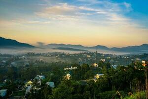 Mountains during dawn. Beautiful natural landscape in the summer time with fog photo