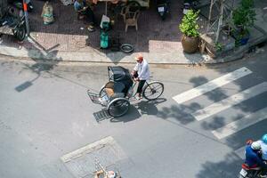 Ho Chi Minh, Viet Nam - 22 April 2023 High view of street in district 5, Ho Chi Minh city, Vietnam. Citizen transport by motorcycles photo