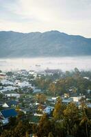 Mountains during dawn. Beautiful natural landscape in the summer time with fog photo