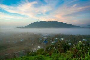 Mountains during dawn. Beautiful natural landscape in the summer time with fog photo