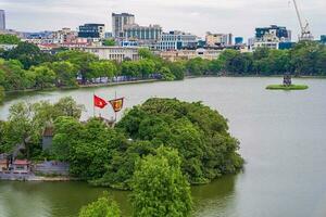 Hanoi, Viet Nam - 13 May 2023 Aerial view of Hoan Kiem Lake  Ho Guom or Sword lake in the center of Hanoi in the fog in the morning. Hoan Kiem Lake is a famous tourist place in Hanoi. Travel concept photo