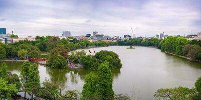 Hanoi, Viet Nam - 13 May 2023 Aerial view of Hoan Kiem Lake  Ho Guom or Sword lake in the center of Hanoi in the fog in the morning. Hoan Kiem Lake is a famous tourist place in Hanoi. Travel concept photo