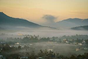 Mountains during dawn. Beautiful natural landscape in the summer time with fog photo