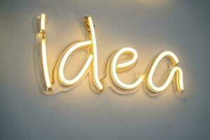 idea, LED neon light on wall ,Business background design with long shadow text photo