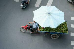 Ho Chi Minh, Viet Nam - 22 April 2023 High view of street in district 5, Ho Chi Minh city, Vietnam. Citizen transport by motorcycles photo