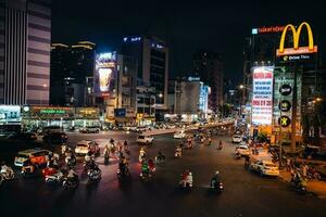 Ho Chi Minh City, Vietnam - Apr 14, 2023 Traffic jam at Dien Bien Phu roundabout with its four-faced clock tower a symbol of Ho Chi Minh city. Light trail from cars. photo