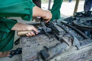 Handmade Rubber Slippers Made From Car Tire in Cu Chi tunnel, Vietnam photo