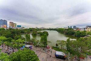 Hanoi, Viet Nam - 13 May 2023 Aerial view of Hoan Kiem Lake  Ho Guom or Sword lake in the center of Hanoi in the fog in the morning. Hoan Kiem Lake is a famous tourist place in Hanoi. Travel concept photo