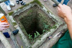 The Cu Chi tunnels. A guide demonstrating how a Vietcong hide into the Tunnel. It's used in Vietnam war. Famous tourist attraction in Vietnam. Stock photo