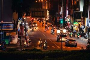 Ho Chi Minh City, Vietnam - Apr 14, 2023 Traffic jam at Dien Bien Phu roundabout with its four-faced clock tower a symbol of Ho Chi Minh city. Light trail from cars. photo