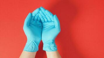 Empty two hand with gloves on red background. photo