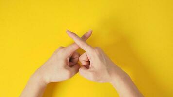 Forbidden or rejection hand sign on yellow background. photo